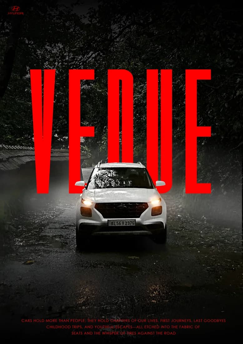 White Hyundai Venue driving through rain with tall red VENUE lettering.