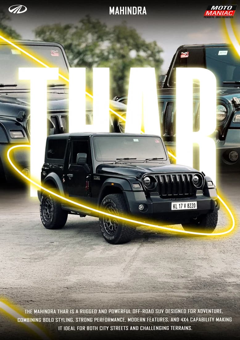Dark Mahindra Thar on pavement with tall white THAR lettering and yellow ring.